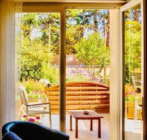 a screened porch with a view of a garden at Mas Saint-Ange in Lunel