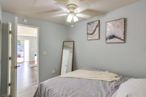a bedroom with a ceiling fan and a bed at Washington Vacation Rental Near Seattle and Tacoma in Des Moines