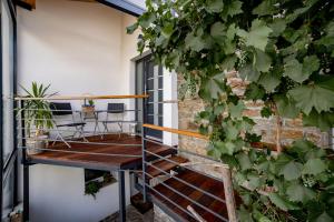a room with a table and chairs on a balcony at Sunny Hill in Vremski Britof