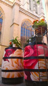 two large vases with plants in them in front of a building at Hotel Mezonvin in Antwerp