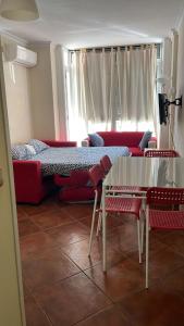 a living room with a couch and a table at APARTAMENTOS VIALIA ESTACIÓN PLAYA in Málaga