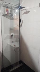 a shower stall with a sink in a bathroom at Apartman BIG Novi Sad in Novi Sad