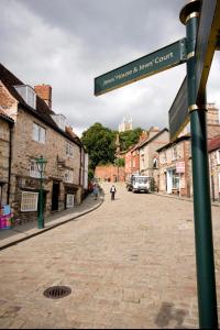 a street sign in the middle of a town at Pass the Keys Centrally located studio Flat in Lincoln