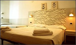 Postel nebo postele na pokoji v ubytování Hotel Luana