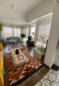 a living room with a couch and a rug at La Perle Pyramids in Cairo +26 photos