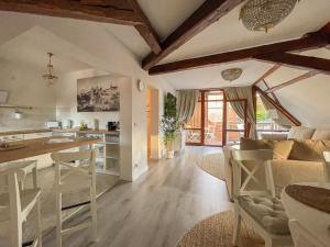 a kitchen and living room with a couch and a table at ApartOne Altstadt-Hotel in Bautzen