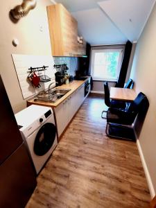 a small kitchen with a sink and a table at Monteurzimmer am Bahnhof Biesenthal - 2 große Apartments in Biesenthal