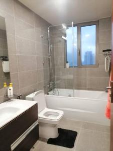 a bathroom with a toilet and a tub and a sink at Luxury Sea view fully furnished apartment in Colombo