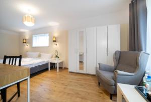 a living room with a bed and a couch and a table at Fala by Marena Wellness & Spa in Międzywodzie +27 photos