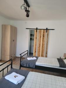 a room with two beds and a cabinet at Casa LADIS in Iernut