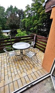 a patio with a table and chairs on a deck at Monteurzimmer am Bahnhof Biesenthal - 2 große Apartments in Biesenthal