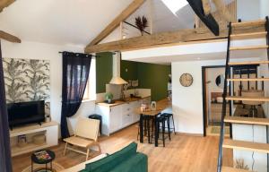 a living room with a loft bed and a kitchen at Gites De la Cour au Grenier in Chauvigny