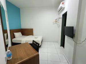 Postel nebo postele na pokoji v ubytování Hotel Wawasan