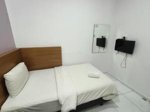 Postel nebo postele na pokoji v ubytování Hotel Wawasan