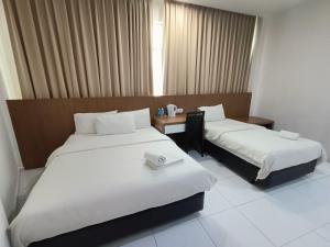 Postel nebo postele na pokoji v ubytování Hotel Wawasan