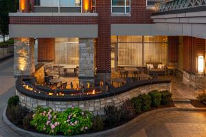 a patio with tables and chairs in front of a building at Courtyard by Marriott Buffalo Downtown/Canalside in Buffalo