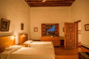 een slaapkamer met 2 bedden en een raam bij Hacienda de San Ignacio in San Ignacio