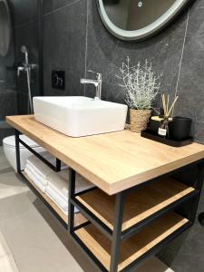 a bathroom with a sink on a wooden table at V Residence Apartments in Rabac +34 photos