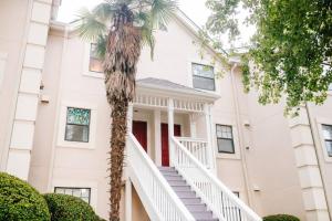 a palm tree in front of a building with stairs at Cozy 3-Bed Athens Getaway, Right Near UGA! in Athens