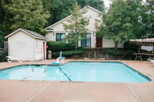 a swimming pool in front of a house at Cozy 3-Bed Athens Getaway, Right Near UGA! in Athens