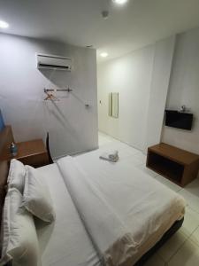 Postel nebo postele na pokoji v ubytování Hotel Wawasan