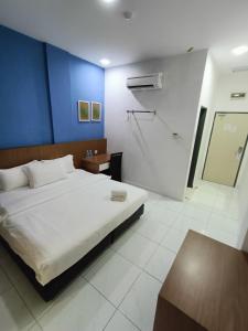 Postel nebo postele na pokoji v ubytování Hotel Wawasan