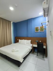 Postel nebo postele na pokoji v ubytování Hotel Wawasan