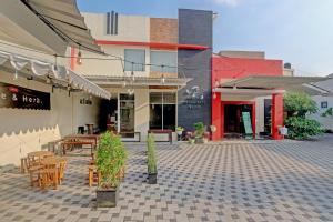 a patio with tables and chairs in front of a building at OYO Capital O 90410 Griya Amanah Jajar Syariah in Solo