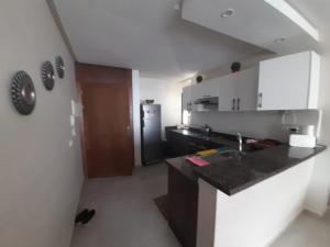 a kitchen with a sink and a counter top at Appartement plage Mehdia in Plage de Mehdia