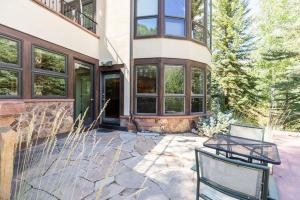 a house with two benches in front of it at Ski In Ski Out condo with Access to Vail Mountain in Vail