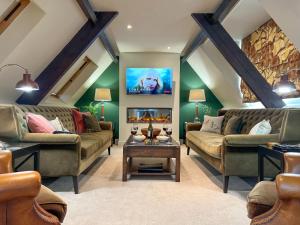 a living room with two couches and a fireplace at Geltsdale Wing, Wetheral in Wetheral