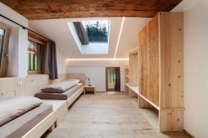 a room with two beds and a skylight at Herrischner Apartement 2 in Corvara in Passiria