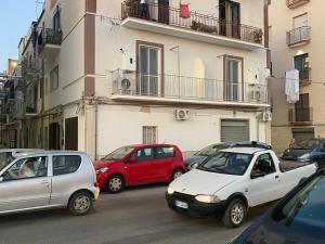 a group of cars parked on a city street at G’S HOME in Margherita di Savoia