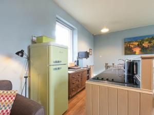 a kitchen with a yellow refrigerator and a stove at Riverbank Cottage in Alnwick