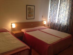 Postel nebo postele na pokoji v ubytování Hotel Rialto