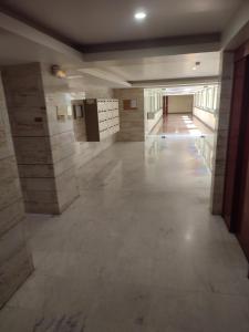 an empty hallway of a building with marble floors and walls at NICE ÉTOILE in Nice