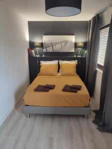 a bedroom with a bed with yellow sheets and pillows at NICE ÉTOILE in Nice