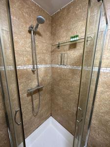 a shower with a glass door in a bathroom at Premium Studio Flat 05 Near Tower Bridge in London