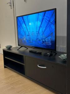 a flat screen tv sitting on top of a dresser at Premium Studio Flat 05 Near Tower Bridge in London