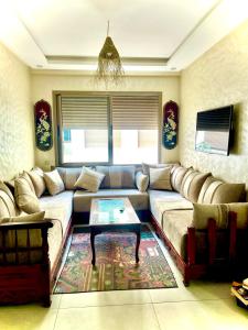 a living room with a couch and a coffee table at Porte de mer Apartement in Essaouira