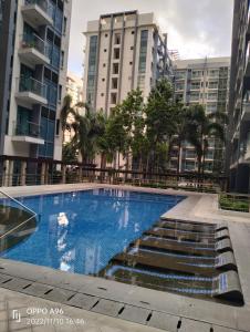 a swimming pool in a city with tall buildings at Pasay City Condotel Near Airport in Manila