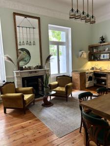 a living room with a fireplace and a table and chairs at Baloo Hostel in Athens