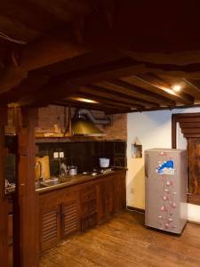 a kitchen with a stainless steel refrigerator and wooden cabinets at Traditional Nepali Style 2 BHK Apartments, Humble Home, Patan in Pātan +18 photos