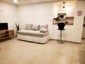 uma sala de estar com uma cama e uma cadeira em House Rental RG_Departamento#1 em Rio Grande