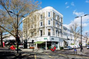 a large building on a city street with cars parked at Veeve - Explorer's Escape in London