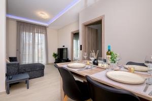 a living room with a dining table and a couch at Alexandra's comfort by homebrain in Alexandroupoli