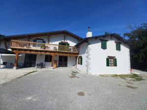 a large white house with a balcony on top at IRATIKO KABIAK in Orbaiceta