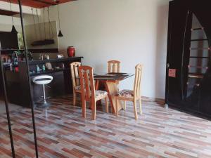 a kitchen with a table and chairs in a room at CASA PROYECTO GIGANTE in Gigante