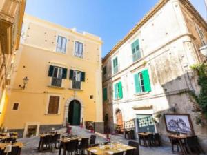 a group of buildings with tables and chairs in a courtyard at BellaVita accomodation in Tropea