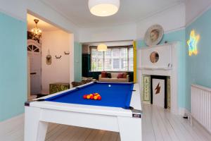 a large living room with a pool table at Veeve - Highgate High Notes in London